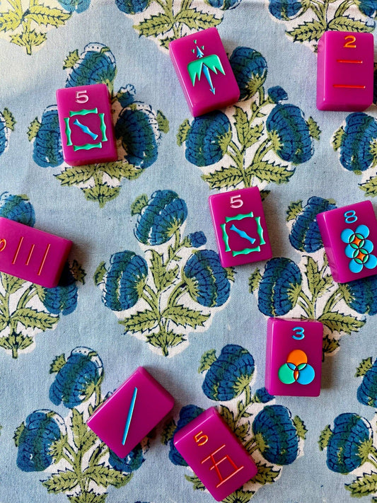 Blue Poms Tablecloth by Christina Dickson Home, 60x60 inches, featuring a vibrant bluebird pattern on a fabric surface.