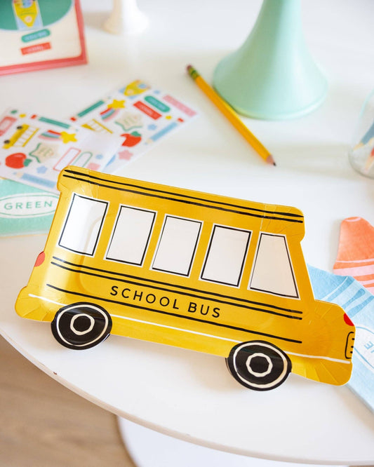 Set of 8 11-inch school bus shaped plates by My Mind’s Eye, featuring bright yellow bus designs for kids' parties.