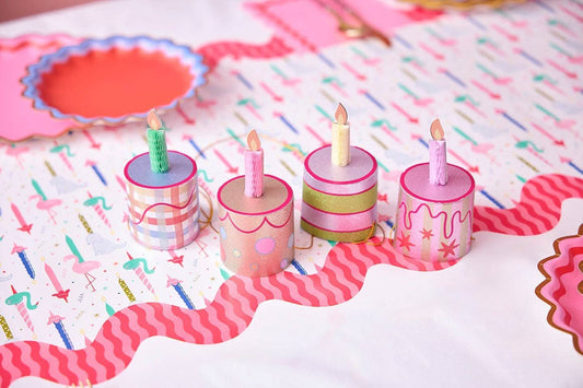 Set of four mini birthday cake-themed party hats by Packed Party, colorful and festive for celebration accessories.