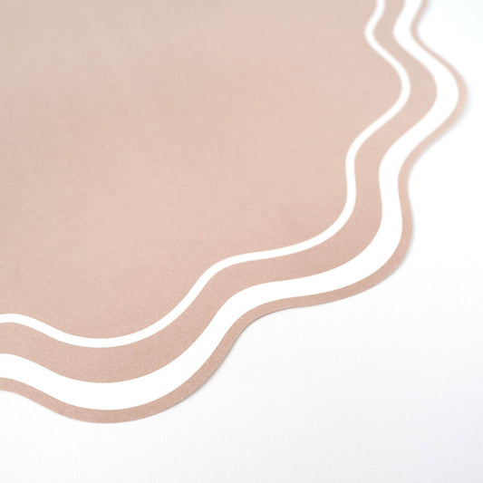 Set of 12 beige wavy scallop paper placemats, 14 inches, by Gatherings by Curated Paperie, showcasing elegant textured design.
