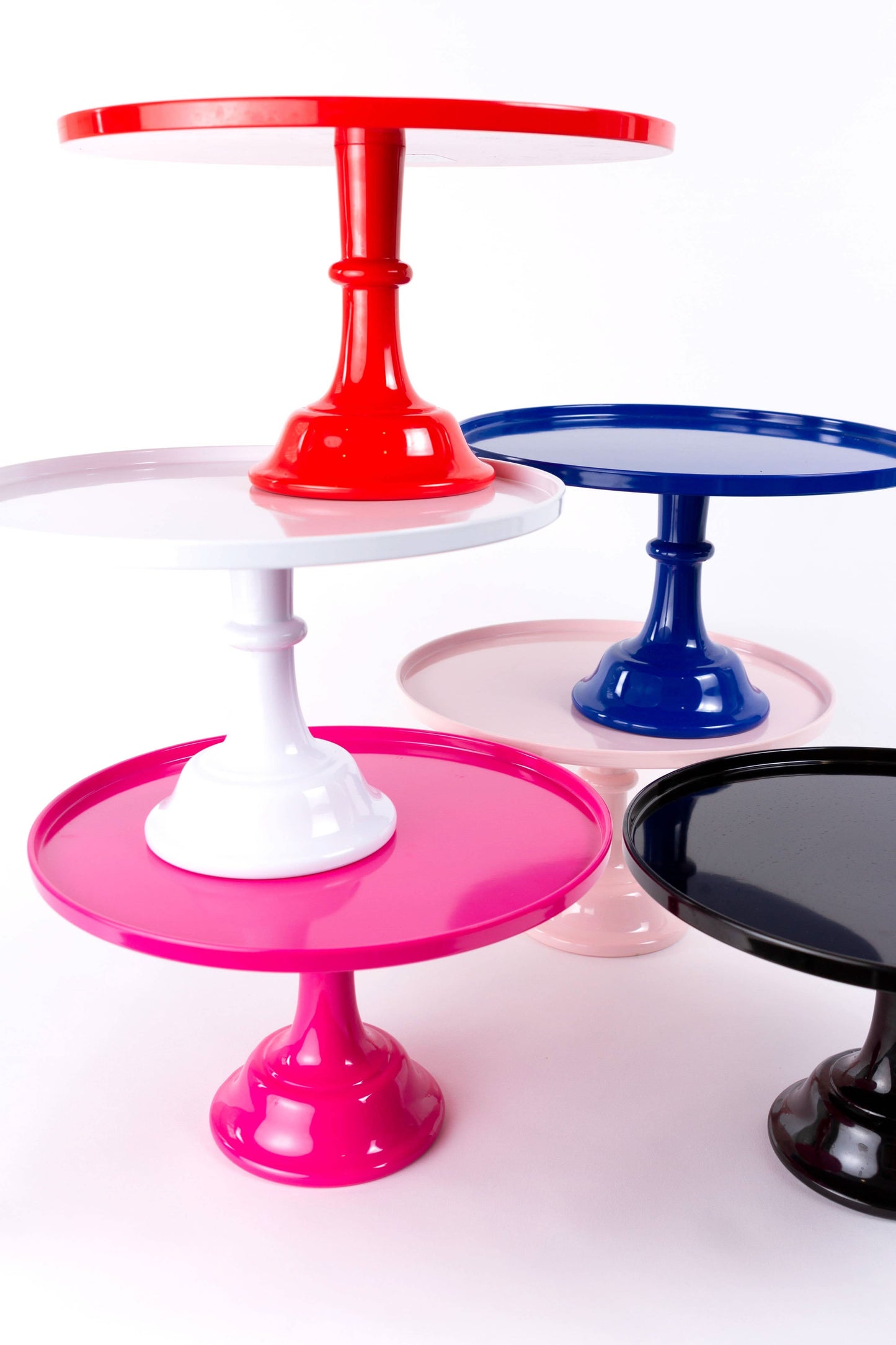Red melamine cake stand displaying cupcakes and desserts, perfect for parties, from Sprinkles & Confetti Party Supplies.