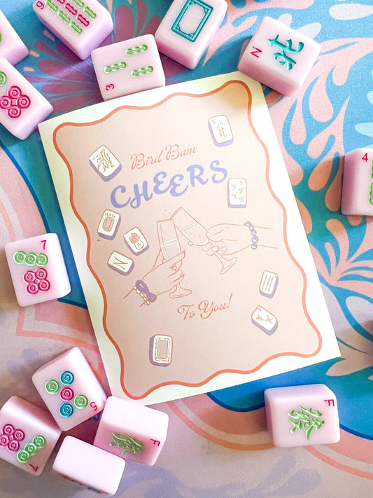 Mahjong greeting card by Thirteenwinks featuring a bird and cheerful "Cheers to You" message, perfect for celebrations and humor.