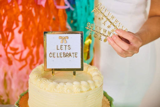 Customizable letterboard cake topper from Packed Party with colorful letters, perfect for birthdays and celebrations.