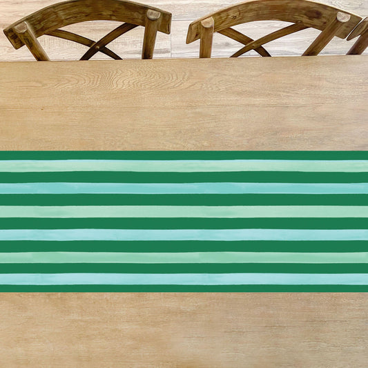 Green stripe Christmas table runner by Cami Monet, 16.5" x 96", featuring holiday-themed fabric perfect for festive table decor.