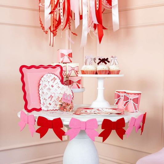 Valentine pink and red felt bow banner by My Mind’s Eye, featuring a decorative string of bows for festive celebrations.