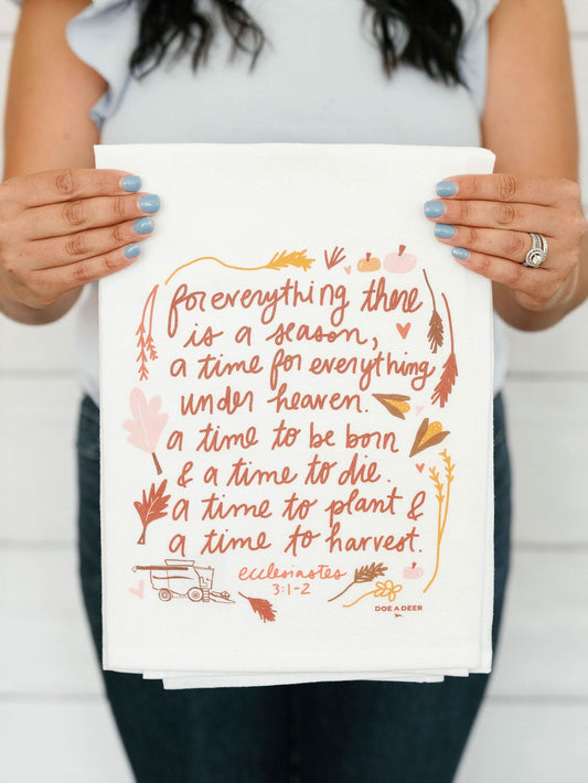 Fall and autumn themed tea towel from Doe A Deer featuring seasonal leaves and warm colors, perfect for kitchen decor.