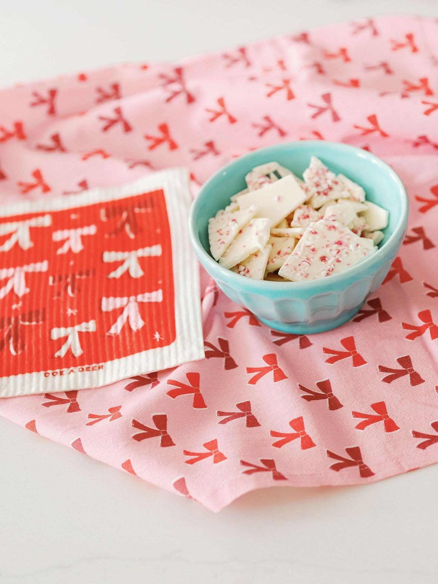 Swedish Dishcloth with a bow tie design by Doe A Deer, featuring colorful patterns on a reusable kitchen cloth.