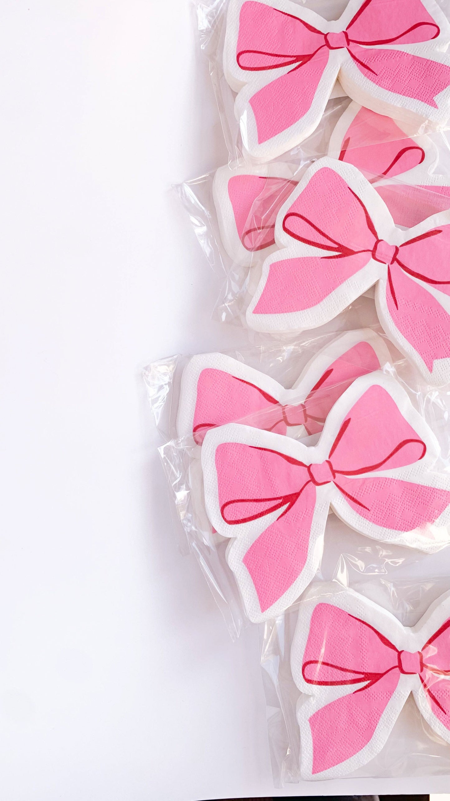 Set of 16 pink bow cocktail napkins by soiree-sisters with elegant bow design for parties and celebrations.