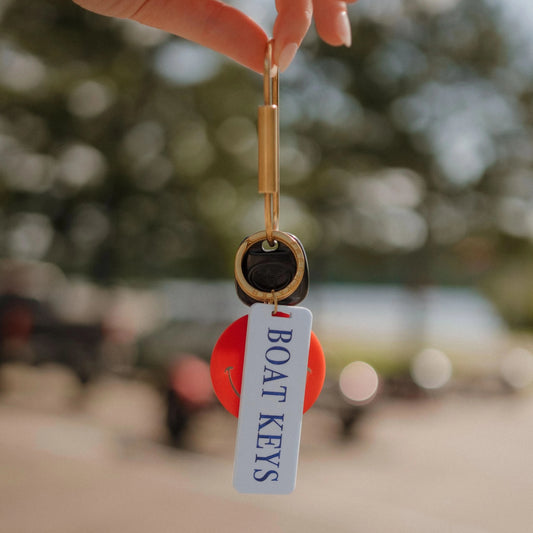 Brass oval key ring with engraved boat design, from Freshwater Curated Goods, on a keychain with multiple keys attached.