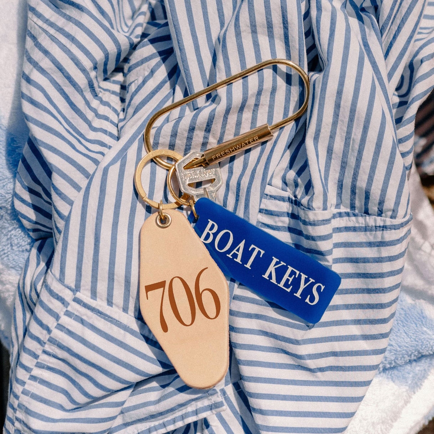 Brass oval key ring with textured finish, featuring a sturdy keychain attachment from Freshwater Curated Goods.