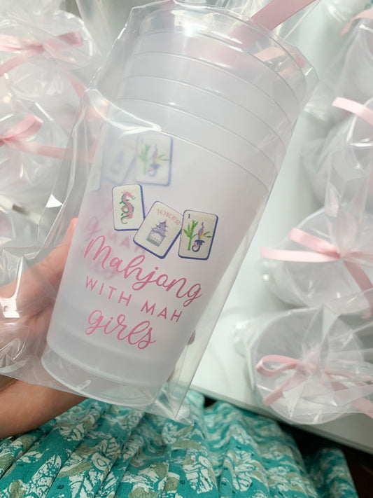 Six frosted ceramic cups featuring mahjong and Mah Girls designs by Porcupine Paper Co., arranged on a wooden surface.