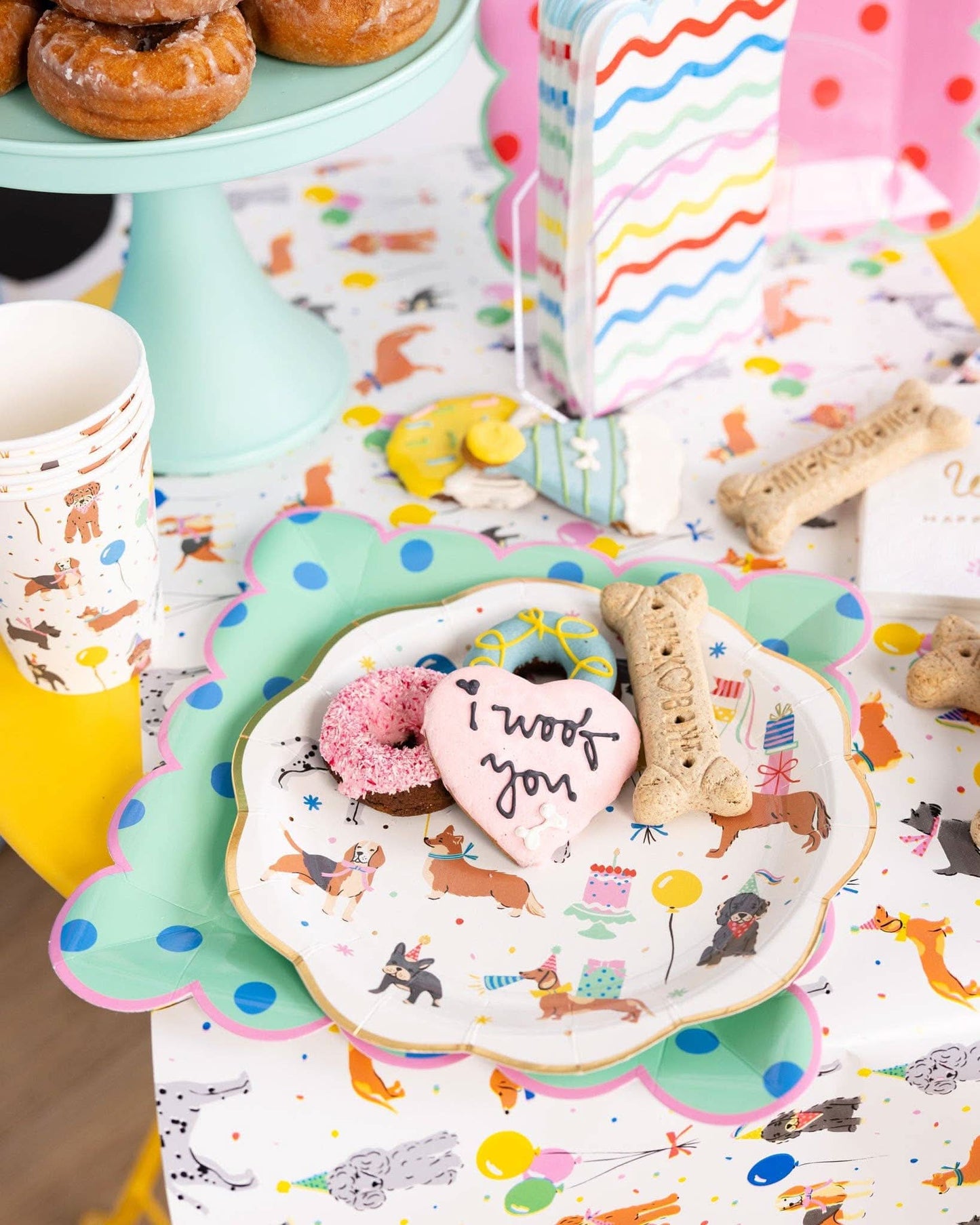 Set of eight 12 oz dog-themed party cups with playful paw print design, suitable for canine celebration events.