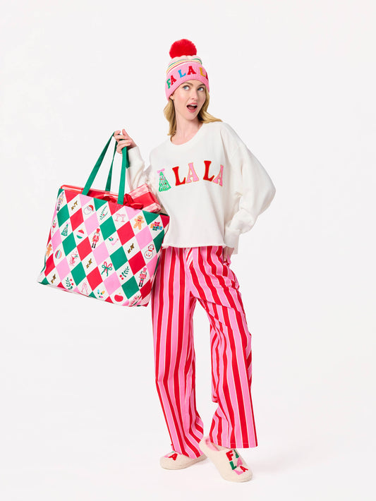 Shiraleah FA LA LA slippers in large/extra-large size with festive red and white design, cozy fleece material, and holiday-themed pattern.