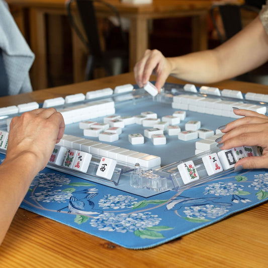 Blue and white bird Mahjong mat by Hutch and Nook, featuring intricate bird patterns on a soft fabric surface.
