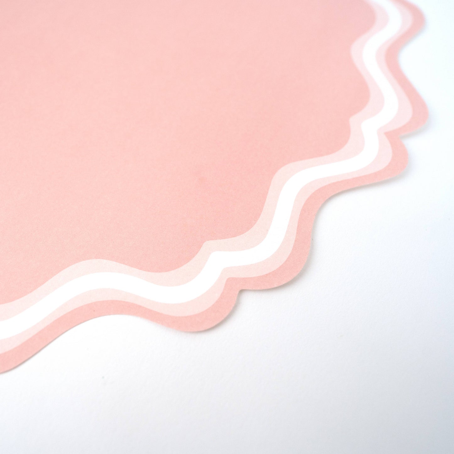 Pink fancy scallop paper placemats from Gatherings by Curated Paperie, 12 count, featuring elegant scalloped edges and decorative design.