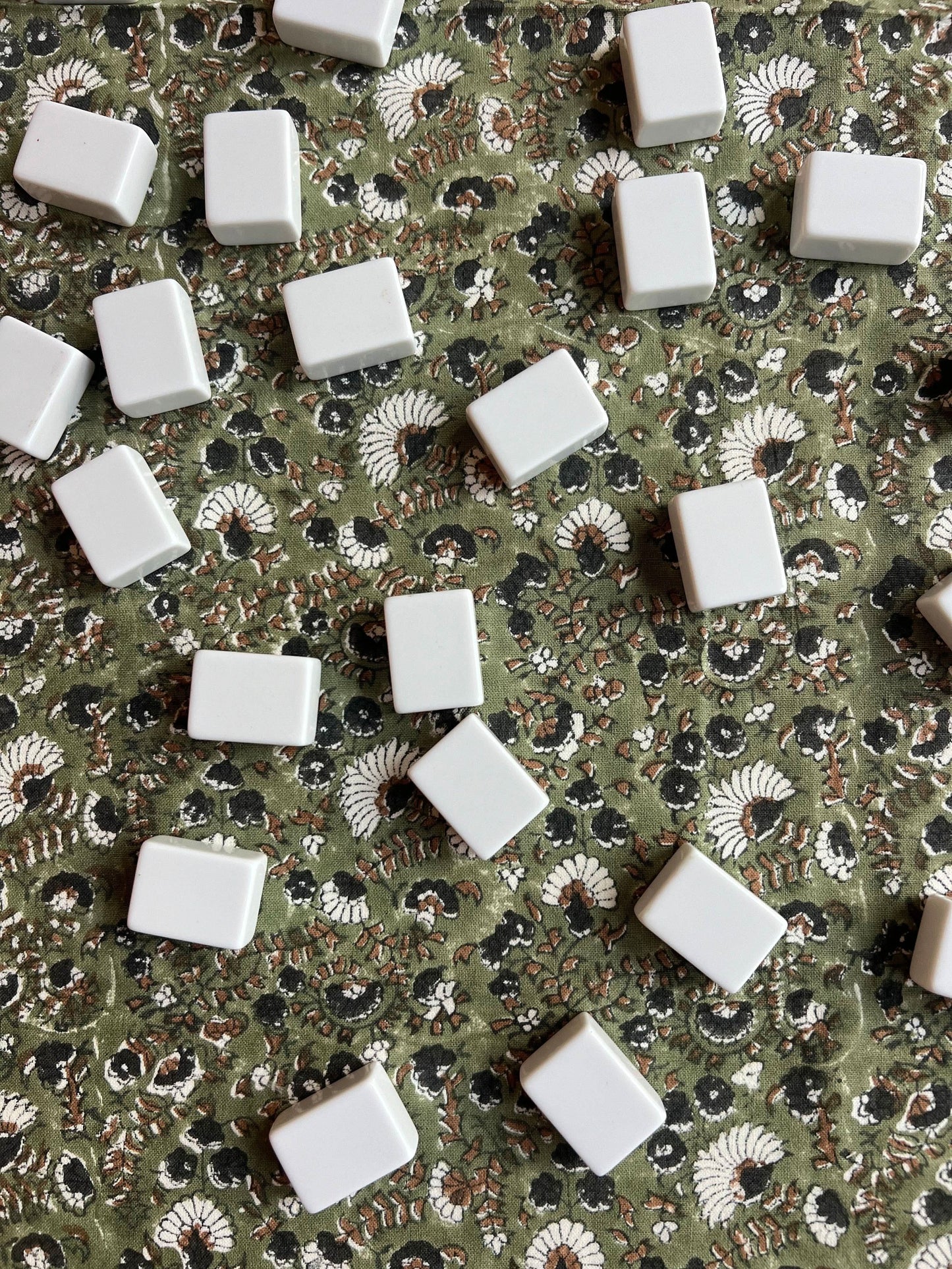 Olive Bustling Florets tablecloth by Christina Dickson Home featuring vibrant floral pattern on smooth fabric.