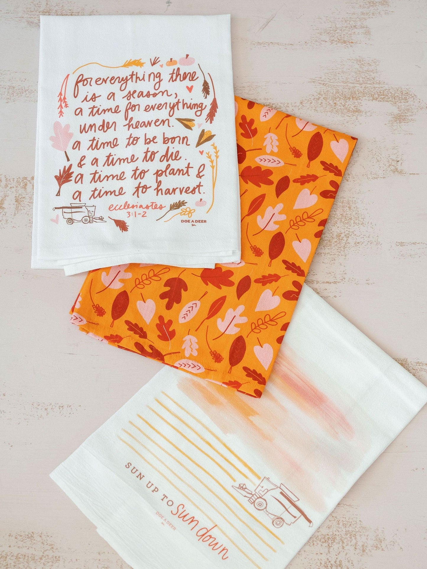 Doe A Deer fall and autumn tea towel featuring seasonal leaf and harvest motifs, perfect for fall kitchen decor.