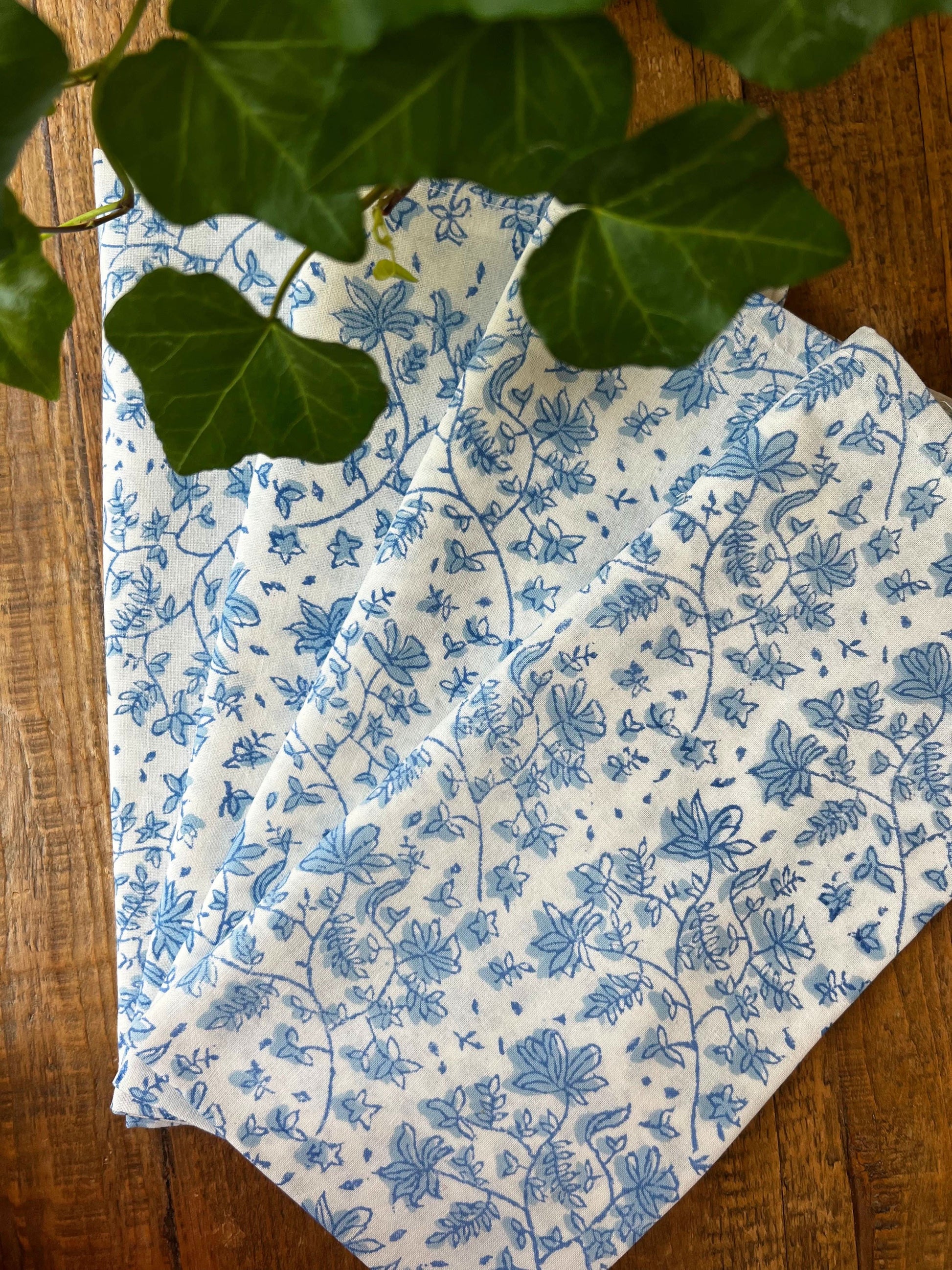 Set of four Christina Dickson Home Whimsy Floral Napkins in Sorrento Blue with vibrant floral pattern for elegant table settings.