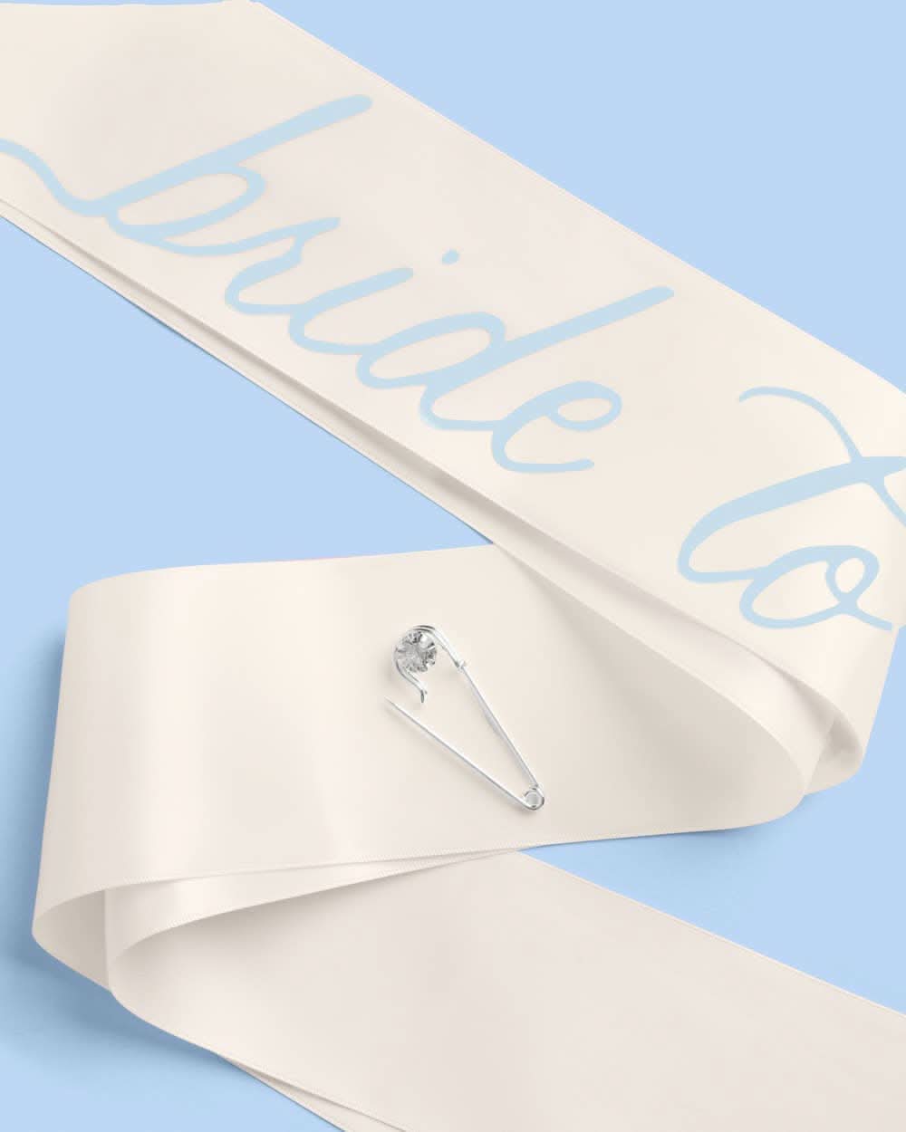 Bride To Be sash from xo, Fetti with white satin fabric and gold lettering, designed for bridal celebrations and bachelorette parties.