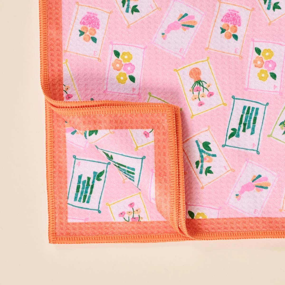 Waffle tea towel featuring "It's Mahj Time" design from The Darling Effect, showing a soft, textured fabric with playful print.