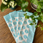 Set of four turquoise Coral Flame napkins by Christina Dickson Home, featuring vibrant coral flame pattern for elegant table decor.