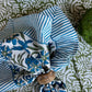 Set of four Christina Dickson Home Pinwheel Napkins in Bluebird with bright, colorful pinwheel patterns on soft fabric.