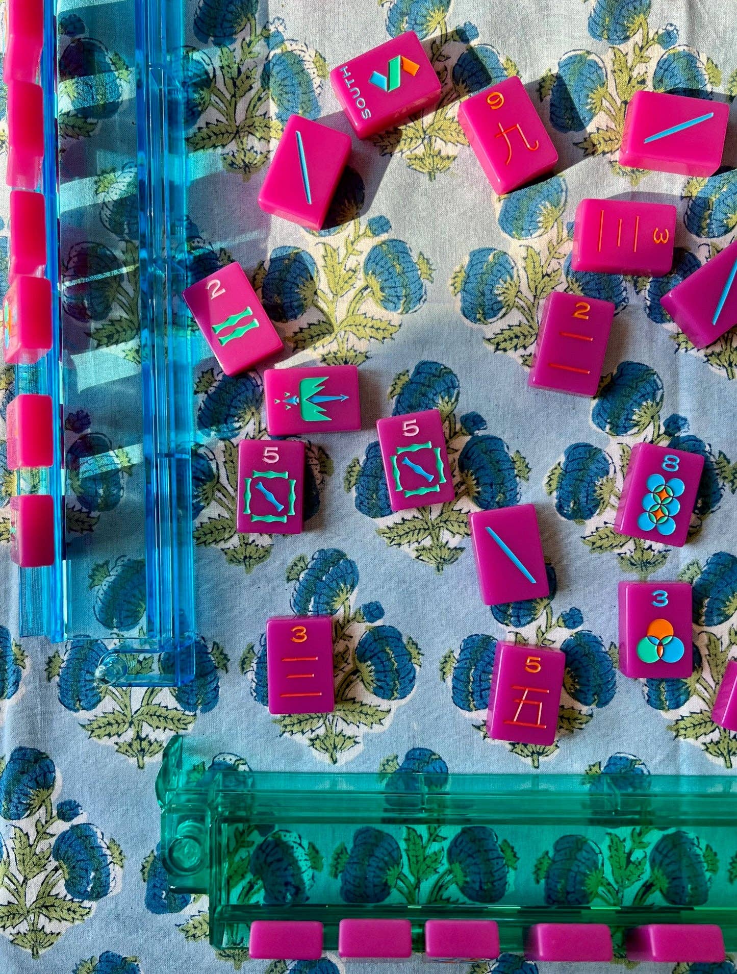 Blue Poms Tablecloth by Christina Dickson Home, 60x60 inches, featuring a vibrant bluebird pattern on a fabric surface.