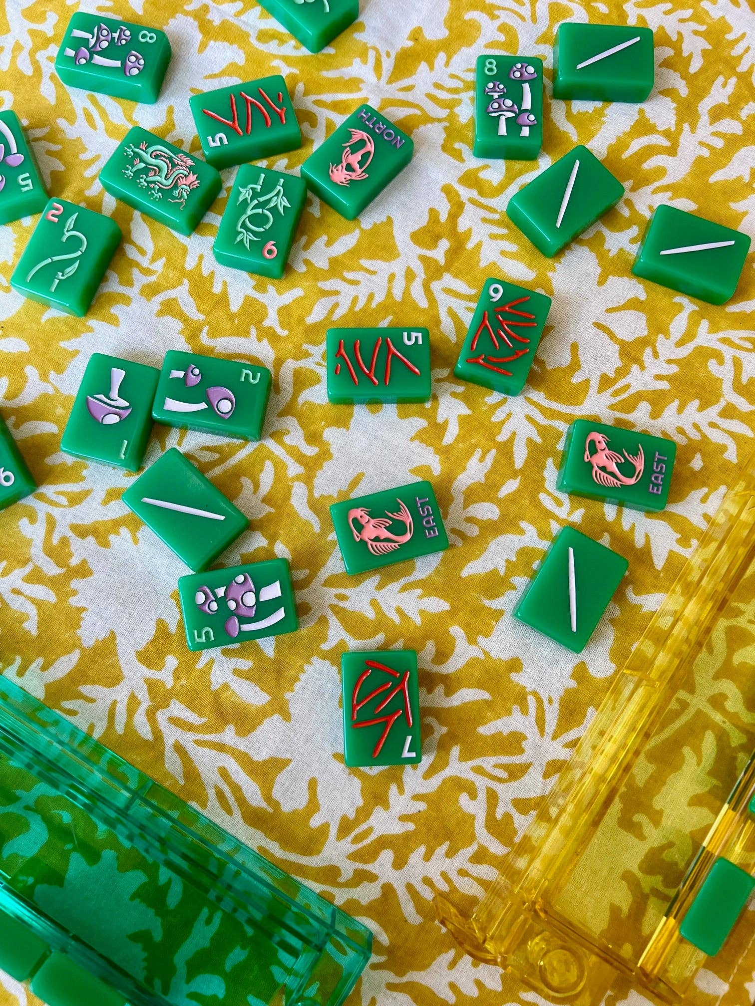 Yellow pressed floral tablecloth by Christina Dickson Home, 60x60 inches, featuring vibrant pressed floral patterns on fabric.