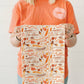 Fall full pattern flour sack towel by Doe A Deer featuring harvest-themed autumn leaves and pumpkins in warm fall colors.