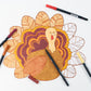 Thanksgiving turkey coloring placemats by Gatherings by Curated Paperie with festive turkey illustrations for kids' holiday activities.