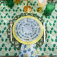 Emerald green Poms tablecloth by Christina Dickson Home, 120x70 inches rectangle, showcasing vibrant fabric and decorative pom details.