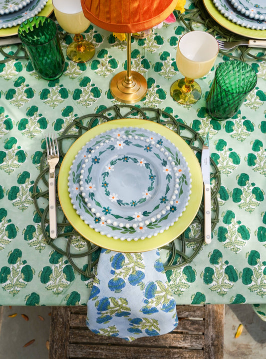 Emerald green Poms tablecloth by Christina Dickson Home, 120x70 inches rectangle, showcasing vibrant fabric and decorative pom details.
