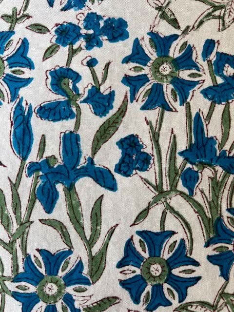 Set of four blue Pinwheel Napkins from Christina Dickson Home, featuring vibrant bluebird design for elegant table setting.