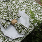 Set of four pressed floral napkins in olive green by Christina Dickson Home, showcasing elegant botanical design.