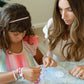 Little Stacks The Shell Kit with colorful plastic shells and tools for creative stacking and building play.