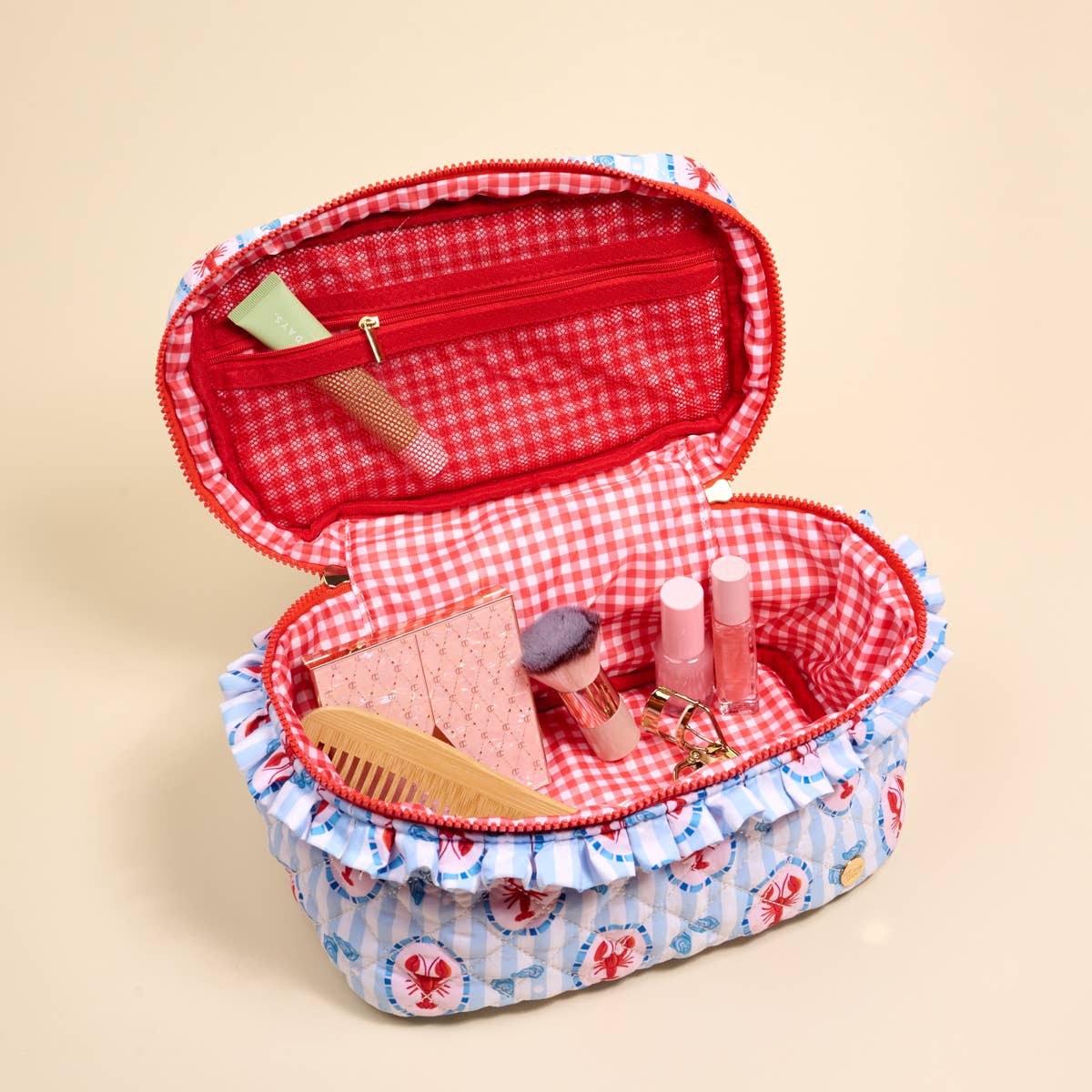 Glam & Go quilted cosmetic bag by Harbor House, with a sleek, padded design and zipper closure for stylish makeup storage.