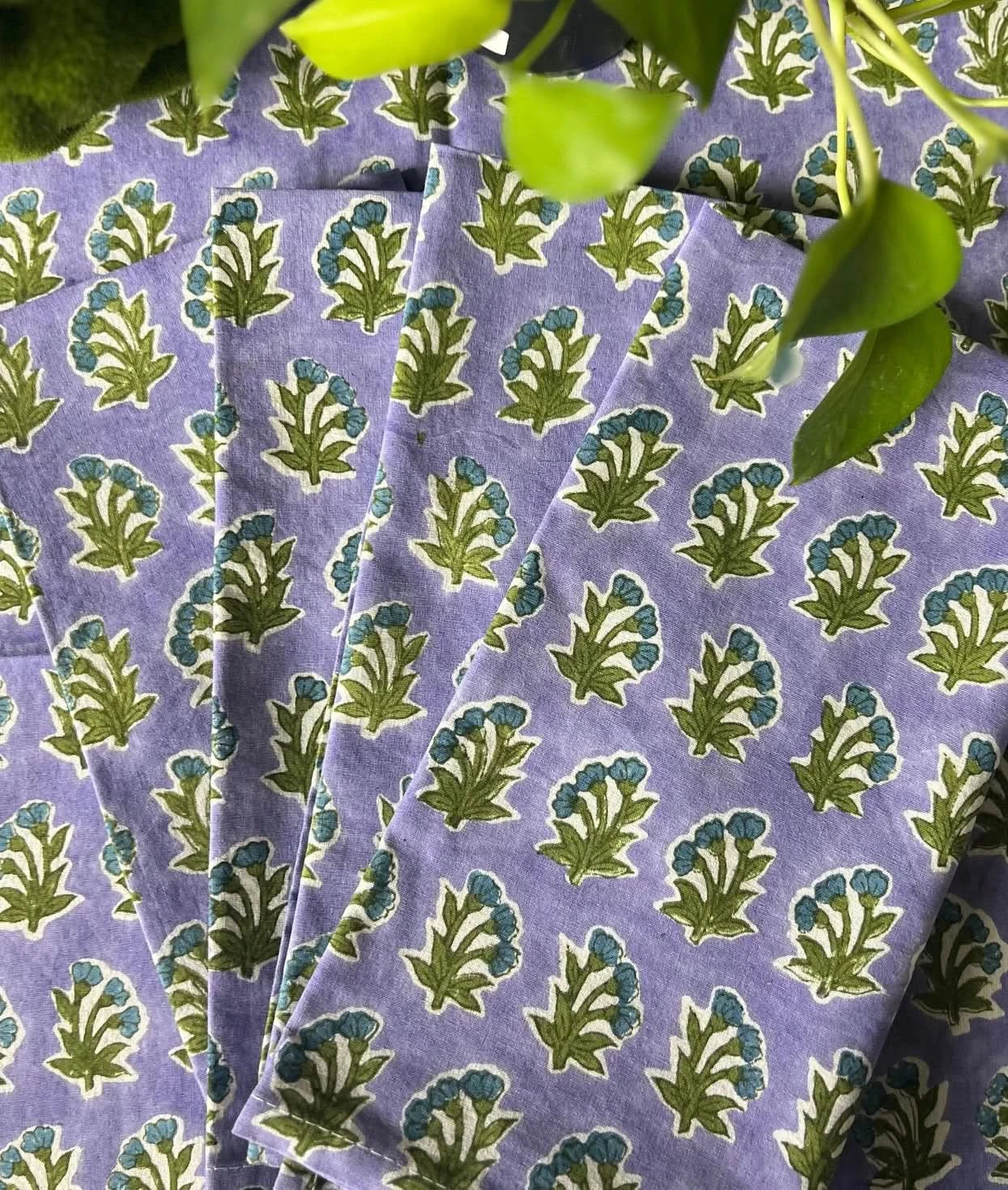 Set of four Christina Dickson Home Triple Flower in Lilac napkins with floral pattern, perfect for elegant table settings.