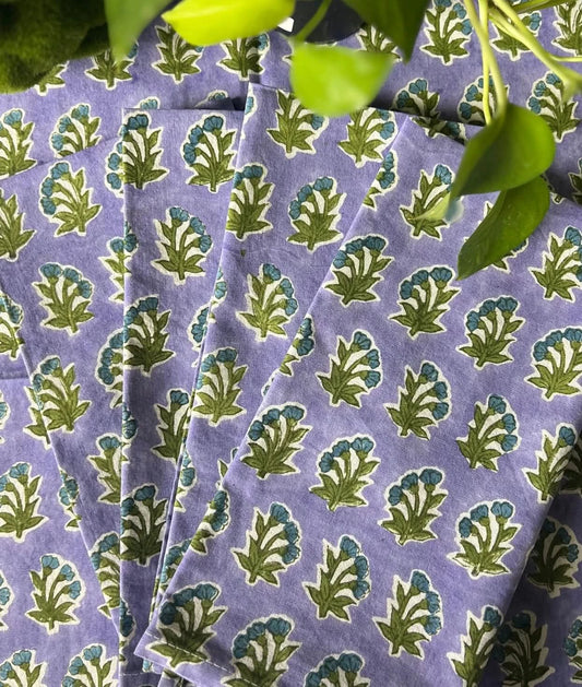 Set of four Christina Dickson Home Triple Flower in Lilac napkins with floral pattern, perfect for elegant table settings.