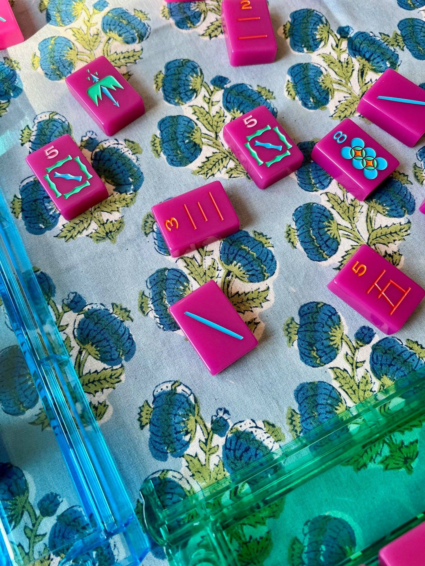 Blue Poms Tablecloth by Christina Dickson Home, 60x60 inches, featuring a vibrant bluebird pattern on crisp fabric.