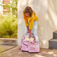 Pink Bows and Confetti Backpack by Packed Party showing cheerful pink bow accents and colorful confetti design on a playful backpack.