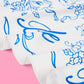 White bridal hair scarf with delicate floral accents, styled in a soft, elegant hair accessory for wedding day or special occasions.