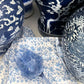 Set of four Christina Dickson Home Whimsy Floral Napkins in Sorrento Blue with vibrant floral pattern on soft fabric.