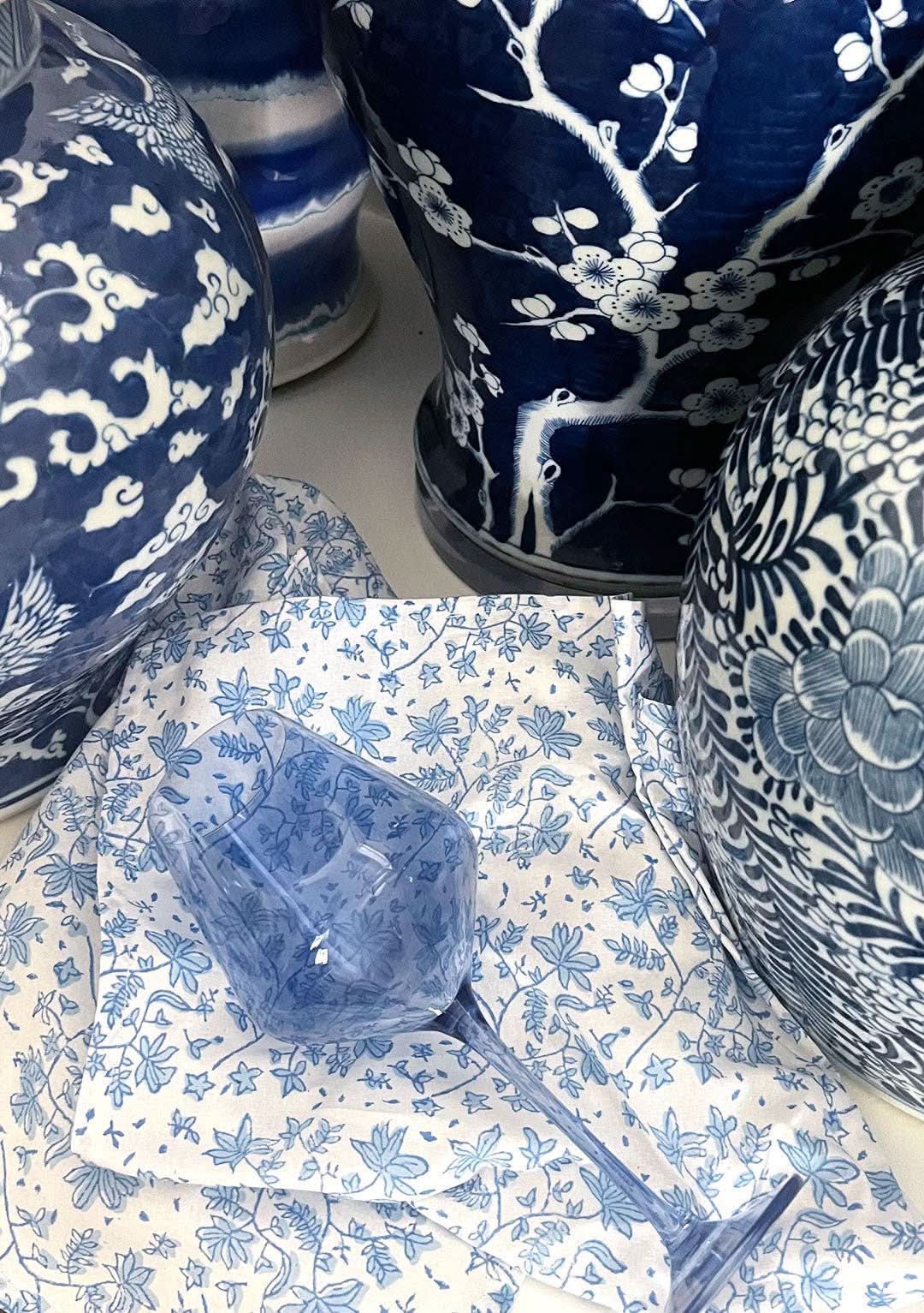 Set of four Christina Dickson Home Whimsy Floral Napkins in Sorrento Blue with vibrant floral pattern on soft fabric.
