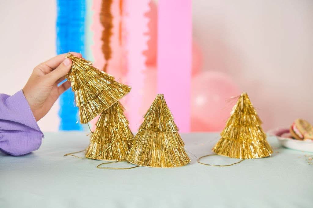 Set of four Golden Girl mini gold fringe party hats by Packed Party, featuring shiny gold fabric and festive fringe details.