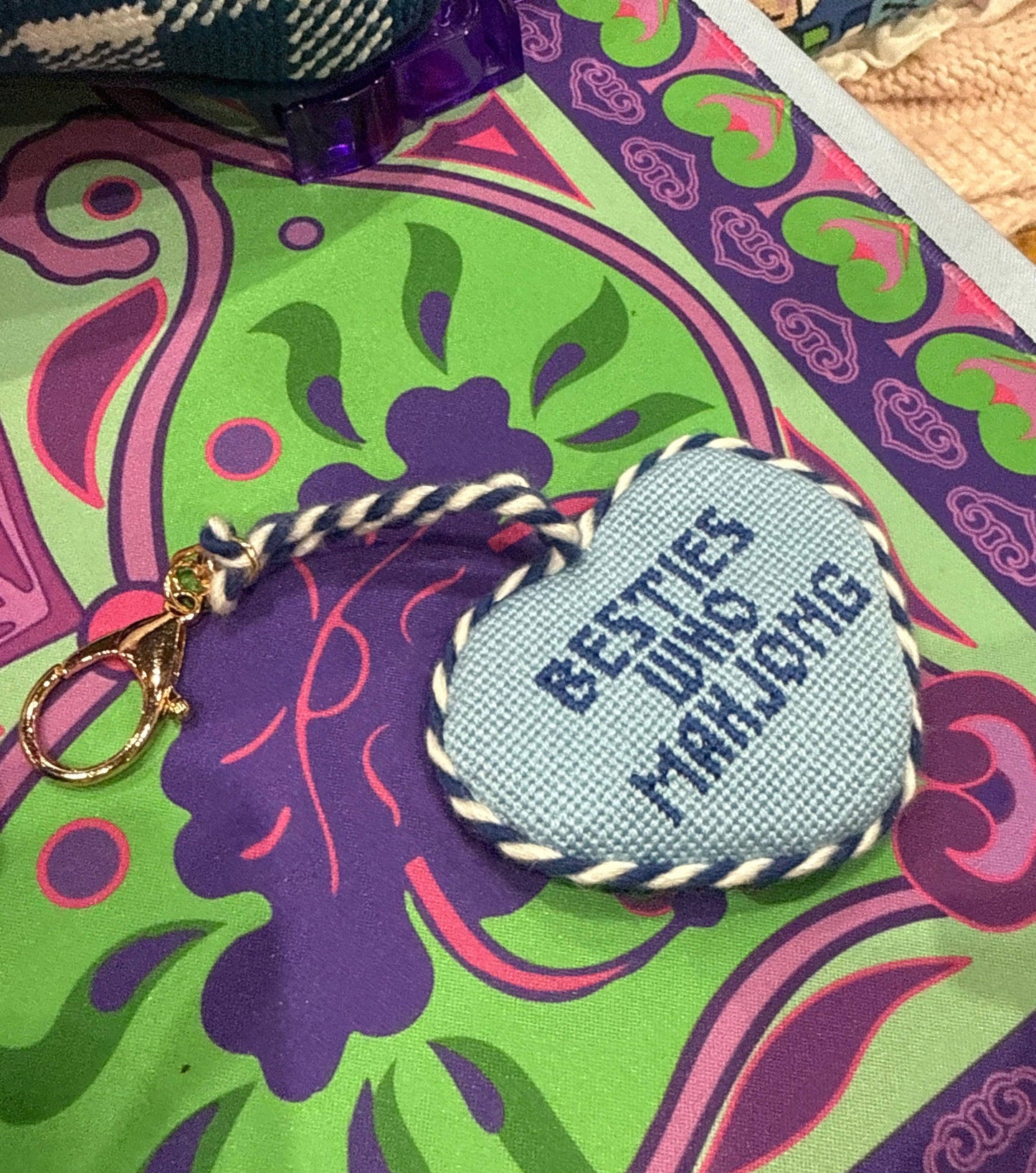Southern Decorative Besties Who Mahjong needlepoint bag charm featuring colorful, detailed embroidery of characters and game tiles.