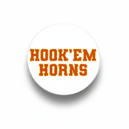 University of Texas Varsity Button by Good Vibez Collegiate, featuring the school's emblem on a metal pin with a blue and orange design.