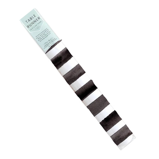 Black and white striped table runner from Cami Monet, 16.5" x 96", featuring bold horizontal stripes on smooth fabric.