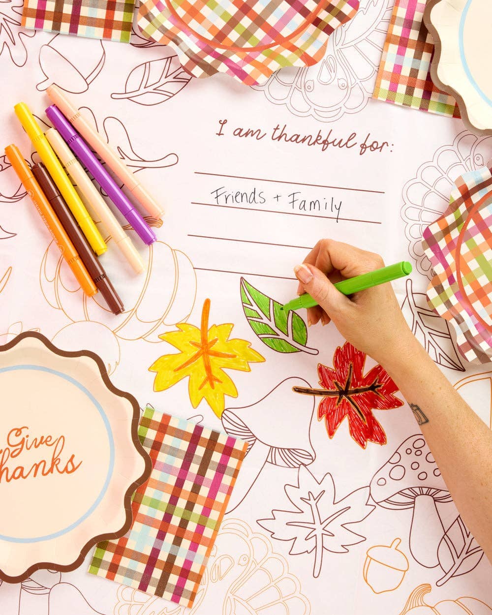 Give Thanks paper tablecloth by xo, Fetti with autumnal leaf and pumpkin designs for Thanksgiving table decor.