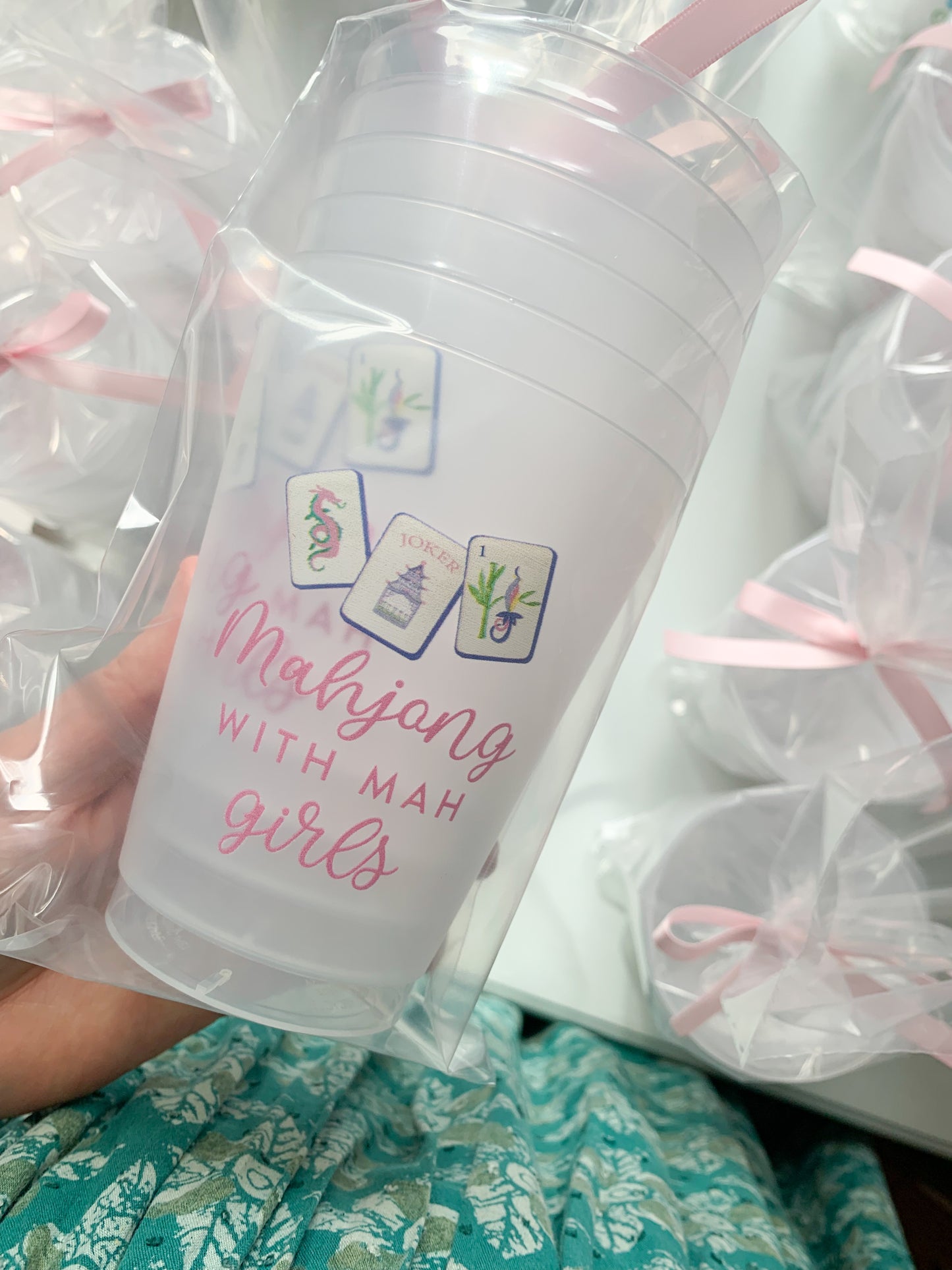 Six frosted ceramic cups featuring mahjong and Mah Girls designs by Porcupine Paper Co., arranged on a wooden surface.