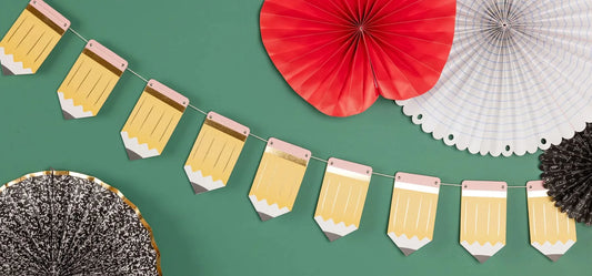 Colorful chipboard pencils banner from My Mind’s Eye featuring illustrated pencil designs on a decorative craft backdrop.